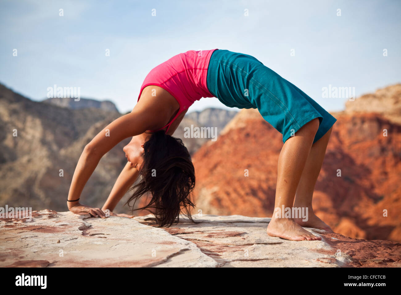 A fit young asian woman practicing yoga while on a rock climbing trip, Red Rocks, Las Vegas, Nevada, United States of America Stock Photo
