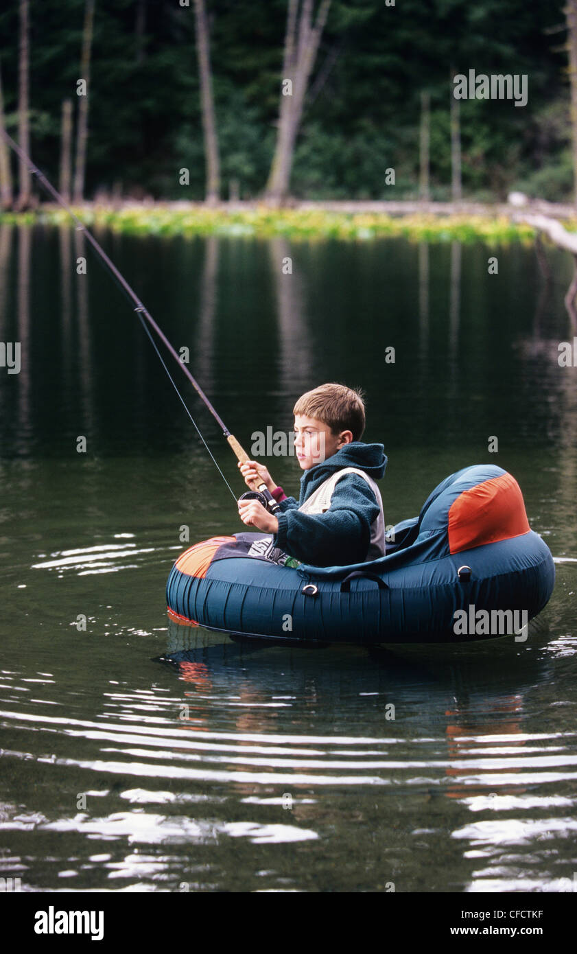 Boy fly fishing from float tube in small lake, British Columbia, Canada  Stock Photo - Alamy