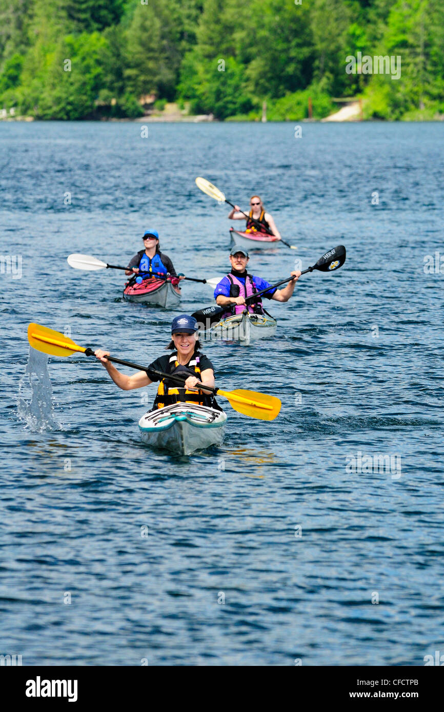 Four kayakers kayaking Cowichan Lake British Stock Photo Alamy
