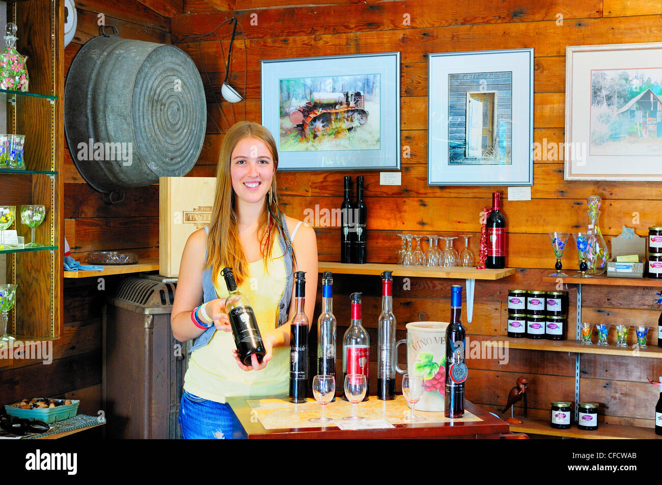 Emily Armour (model release) holding a bottle of award winning wine at the Silverside Farm in Cobble Hill, BC. Stock Photo