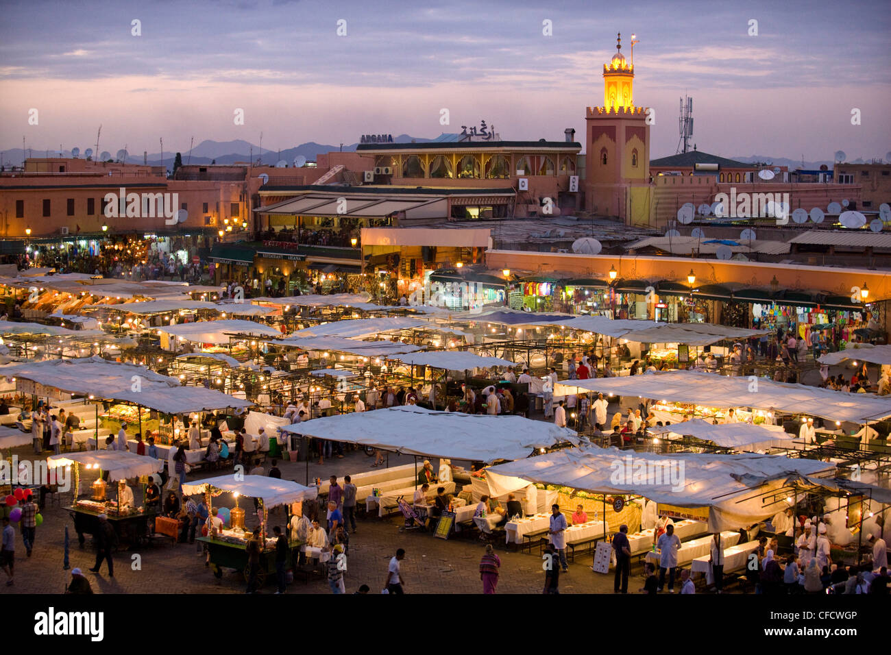 View over Djemaa el Fna at dusk with foodstalls that are set-up daily to serve tourists and locals, Marrakech, Morocco Stock Photo