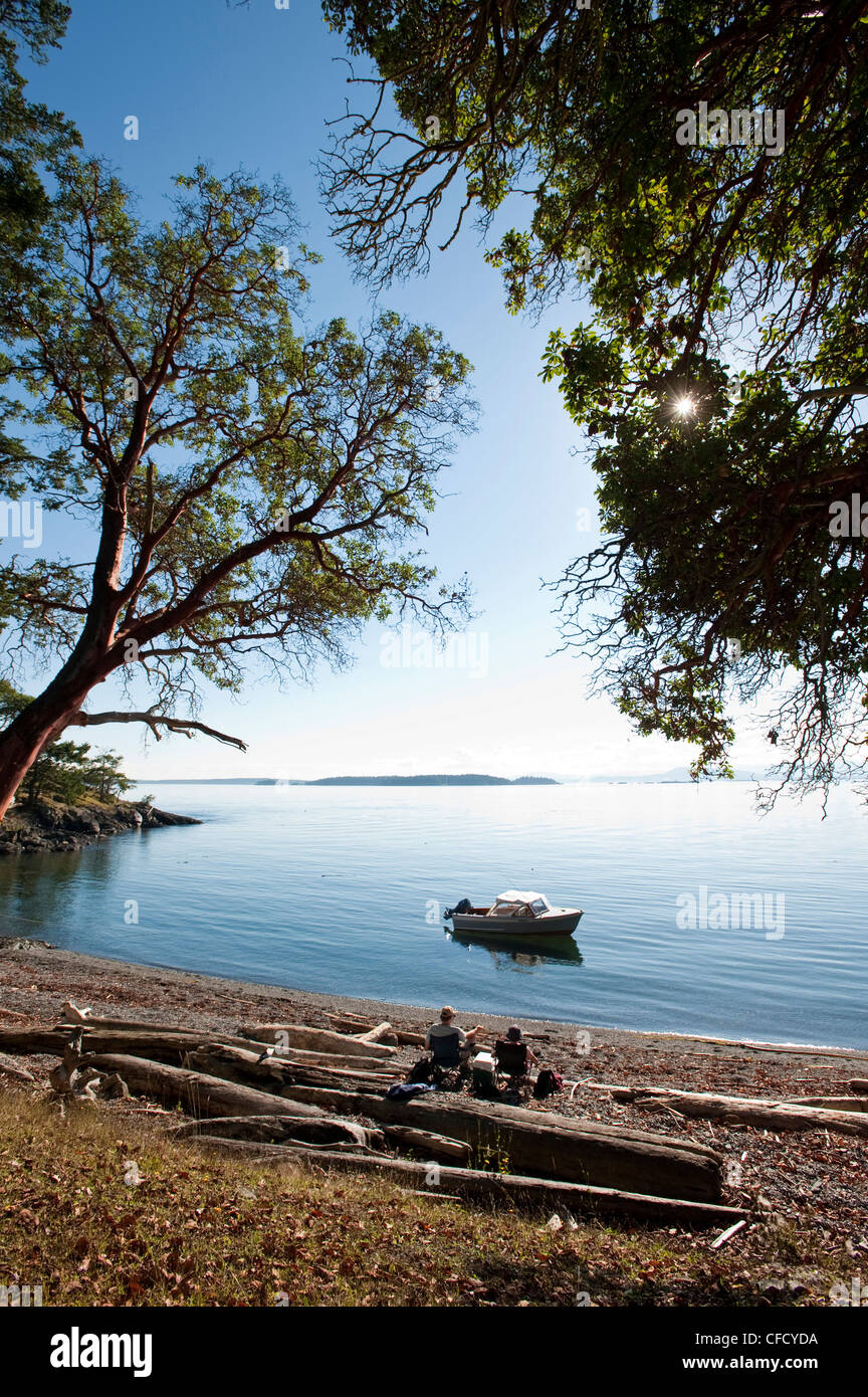 Recreational boaters enjoy quiet beach on small Gulf Island, British Columbia, Canada Stock Photo