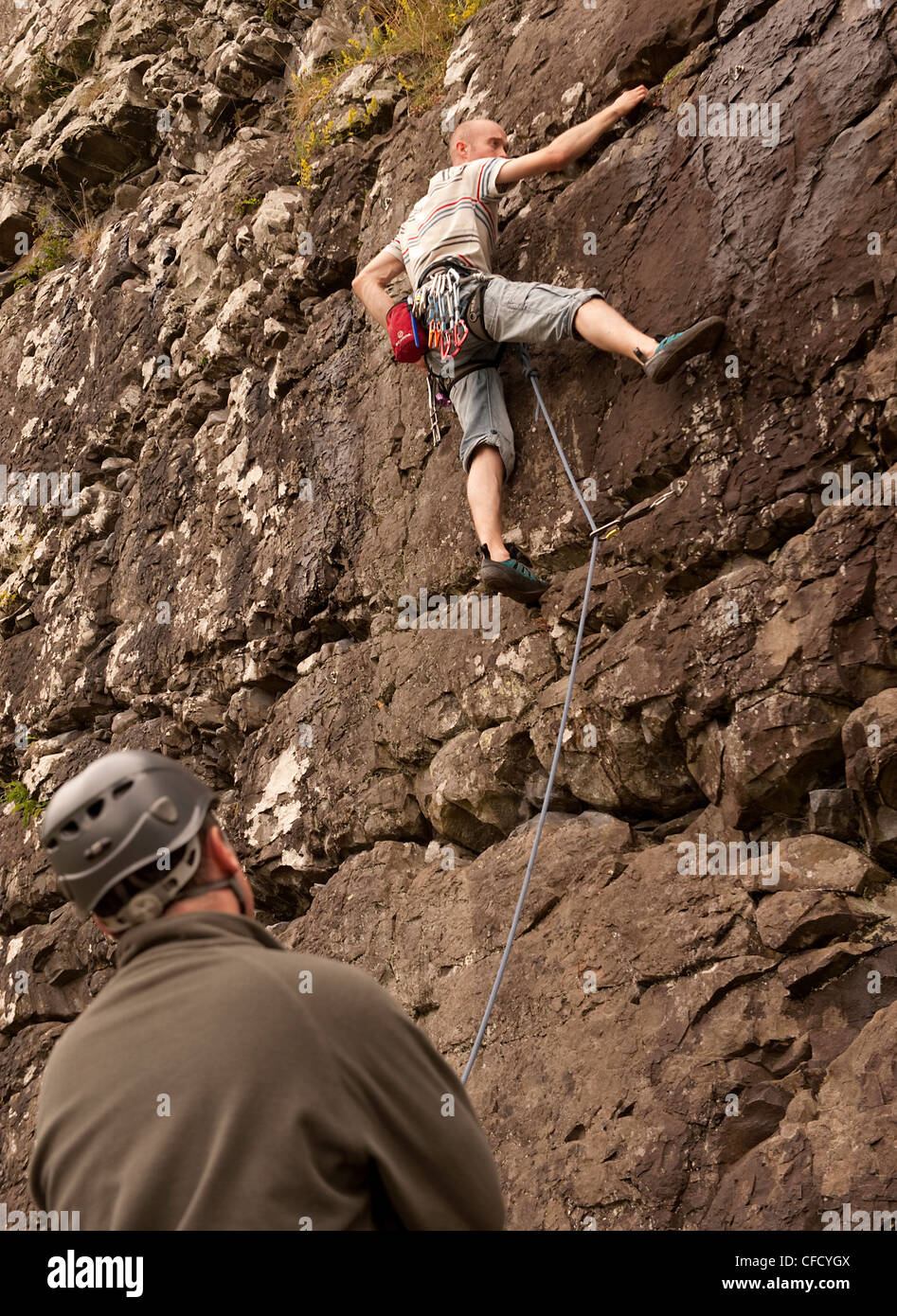 A climber nears wet rock on a sport route in Benny Beg, Scotland, while