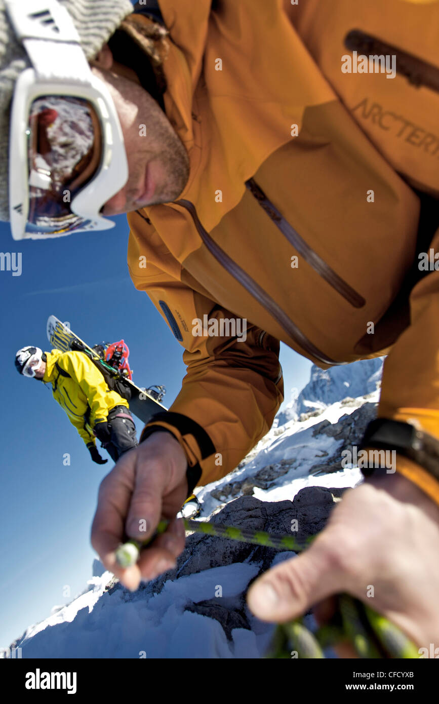 Snowboarder preparing a climbing rope, Oberjoch, Bad Hindelang, Bavaria, Germany Stock Photo