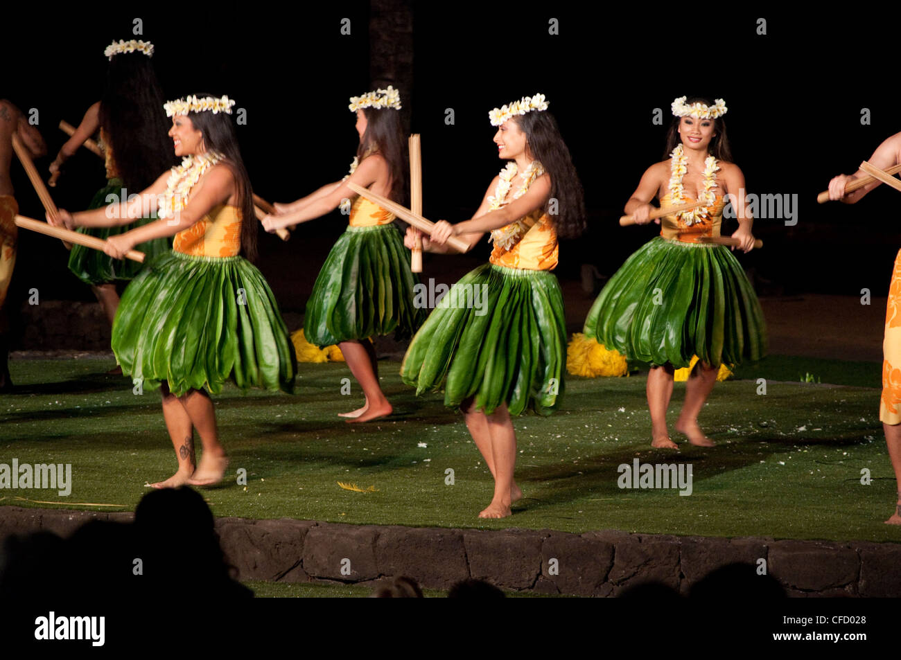 Hula dancers with Pūʻili (split bamboo sticks), Old Lahaina Luau, Maui, Hawaii, United States of America Stock Photo
