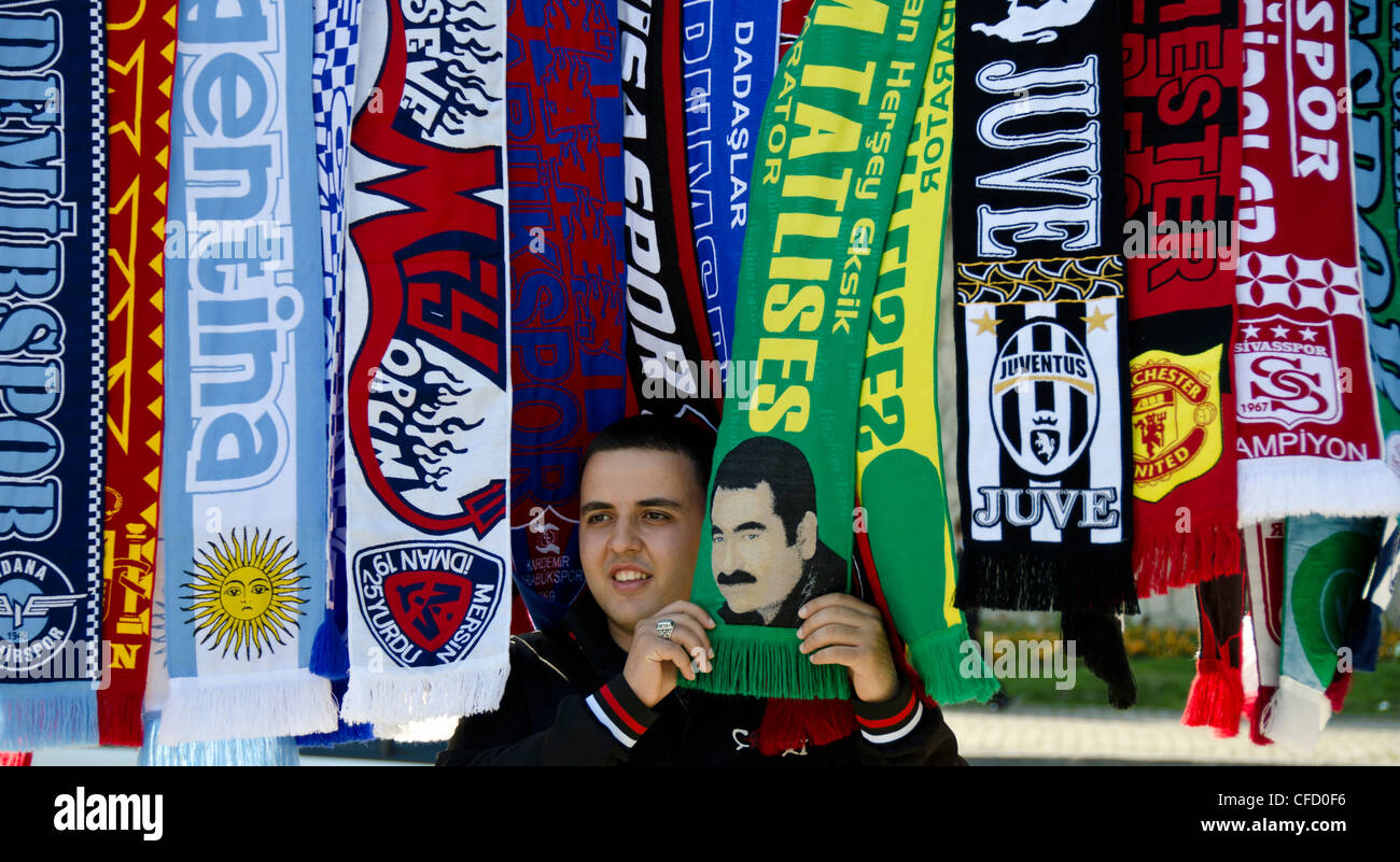 Man with scarves, holding İbrahim Tatlıses (Turkish pop-folk singer) scarf, Istanbul, Turkey Stock Photo