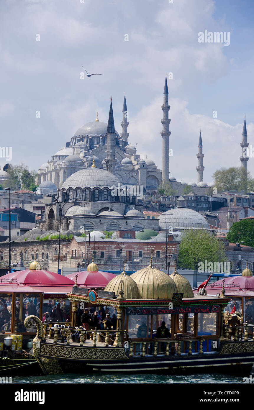 Floating restaurants and the Rüstem Pasha Mosque, located in the Eminönü district of Istanbul, Turkey. Stock Photo