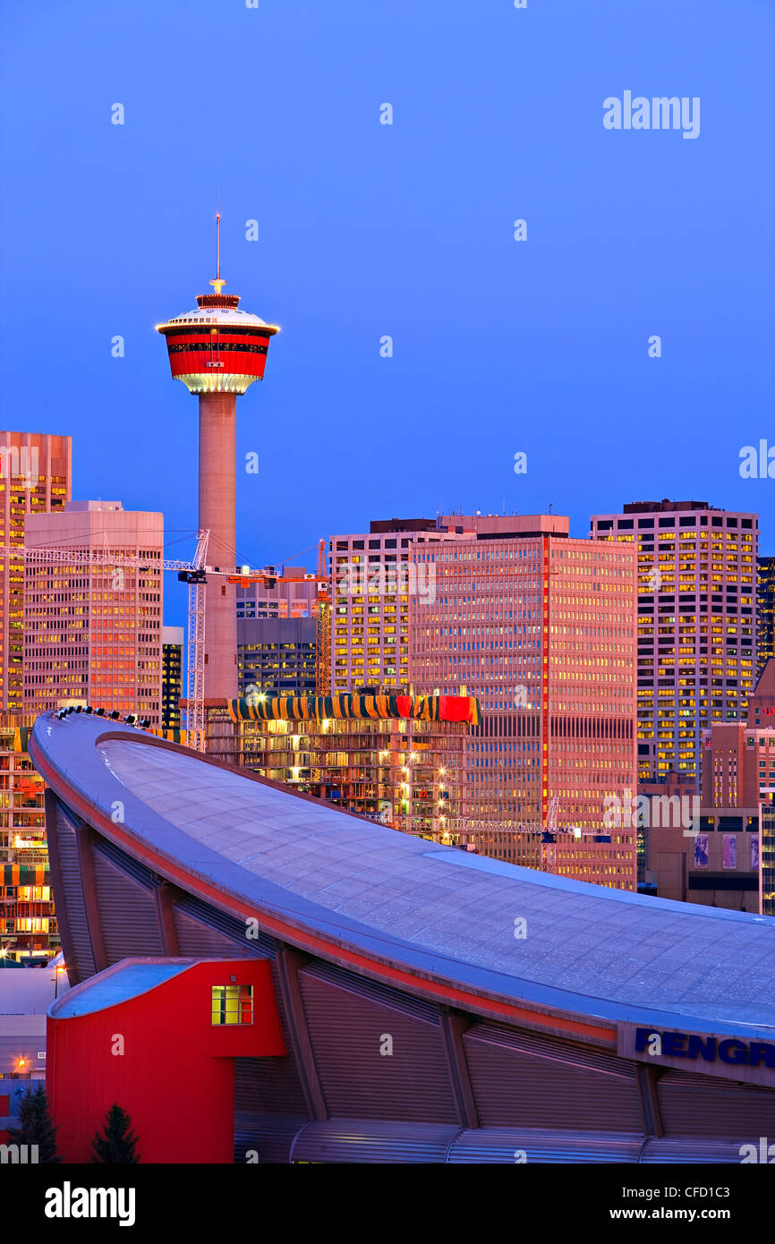 The Saddledome with highrise buildings and the Calgary Tower in the