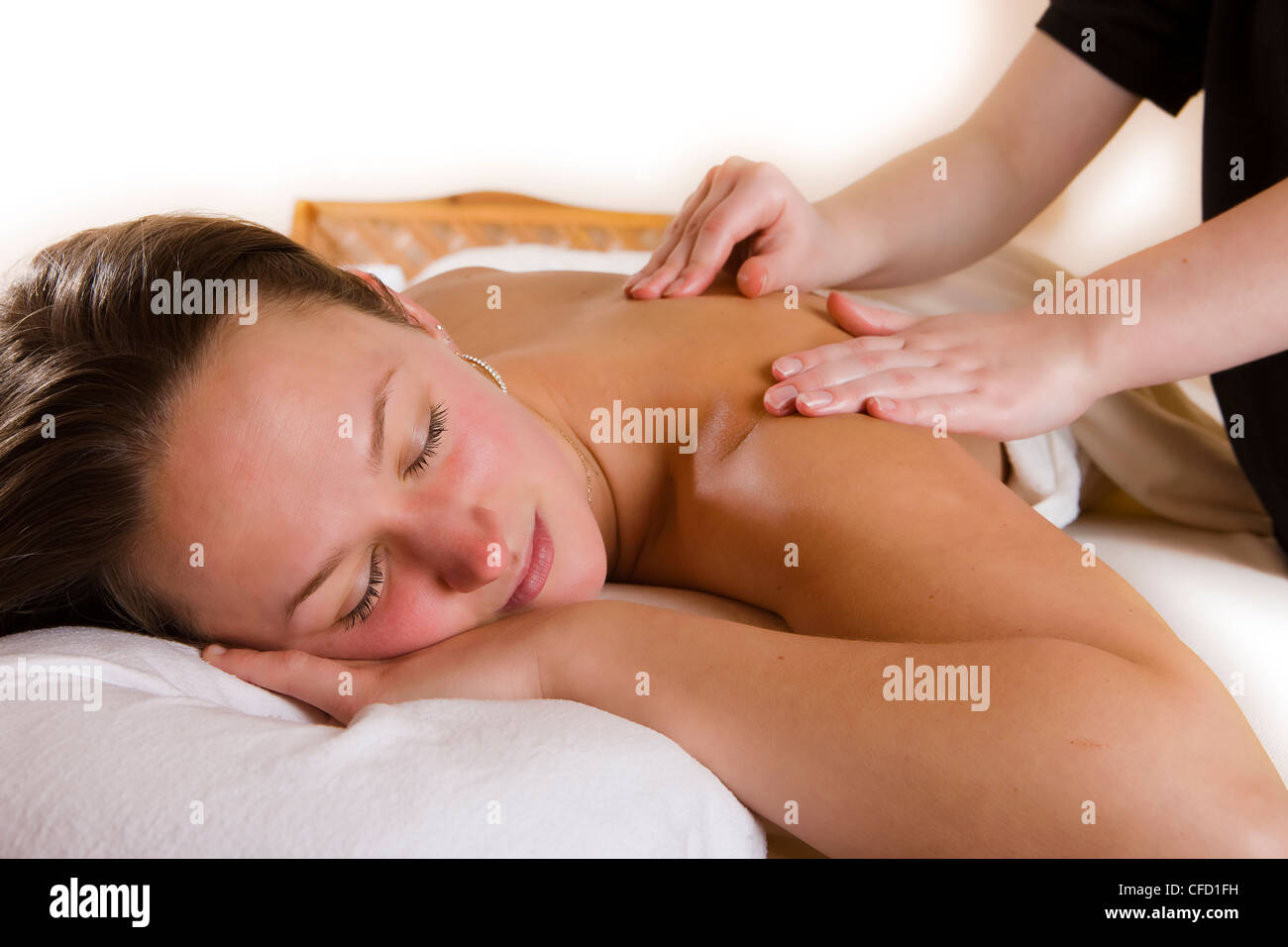 Young female receiving relaxing body massage Stock Photo