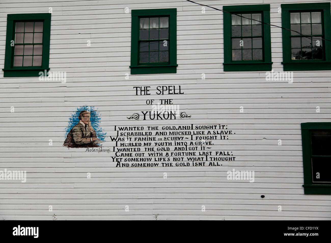 The Spell of the Yukon part of a poem by Robert Service written on the side of a building in Dawson City, Yukon, Canada Stock Photo