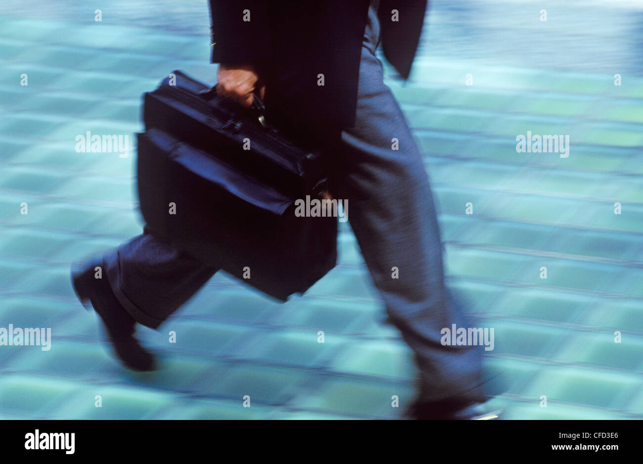 Business man walking with brief case, British Columbia, Canada. Stock Photo
