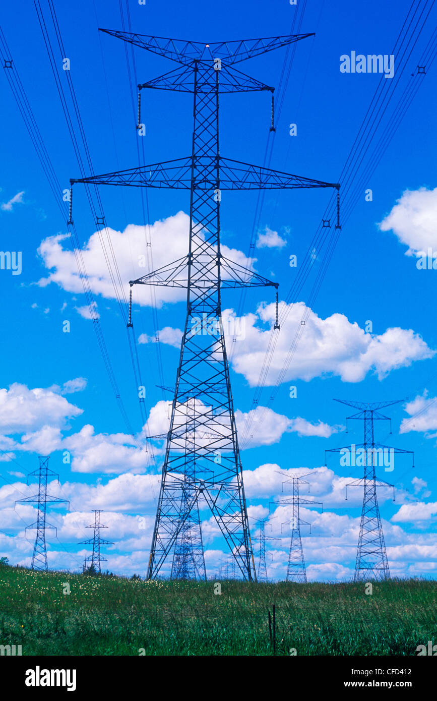 Hydro transmission towers cumulus cloud background, British Columbia