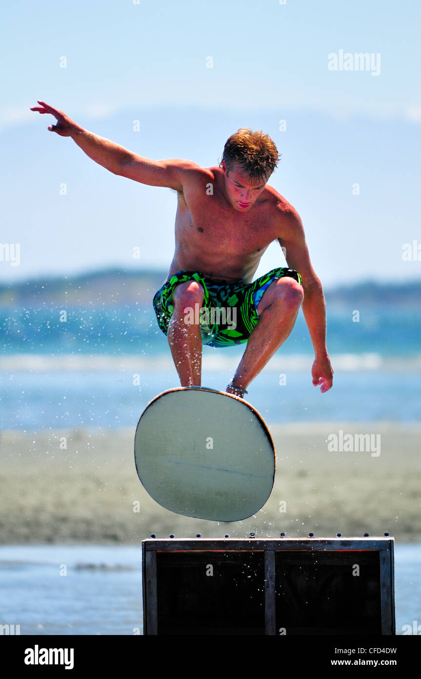 Skimboarder  gets some air jump during 2010 Stock Photo
