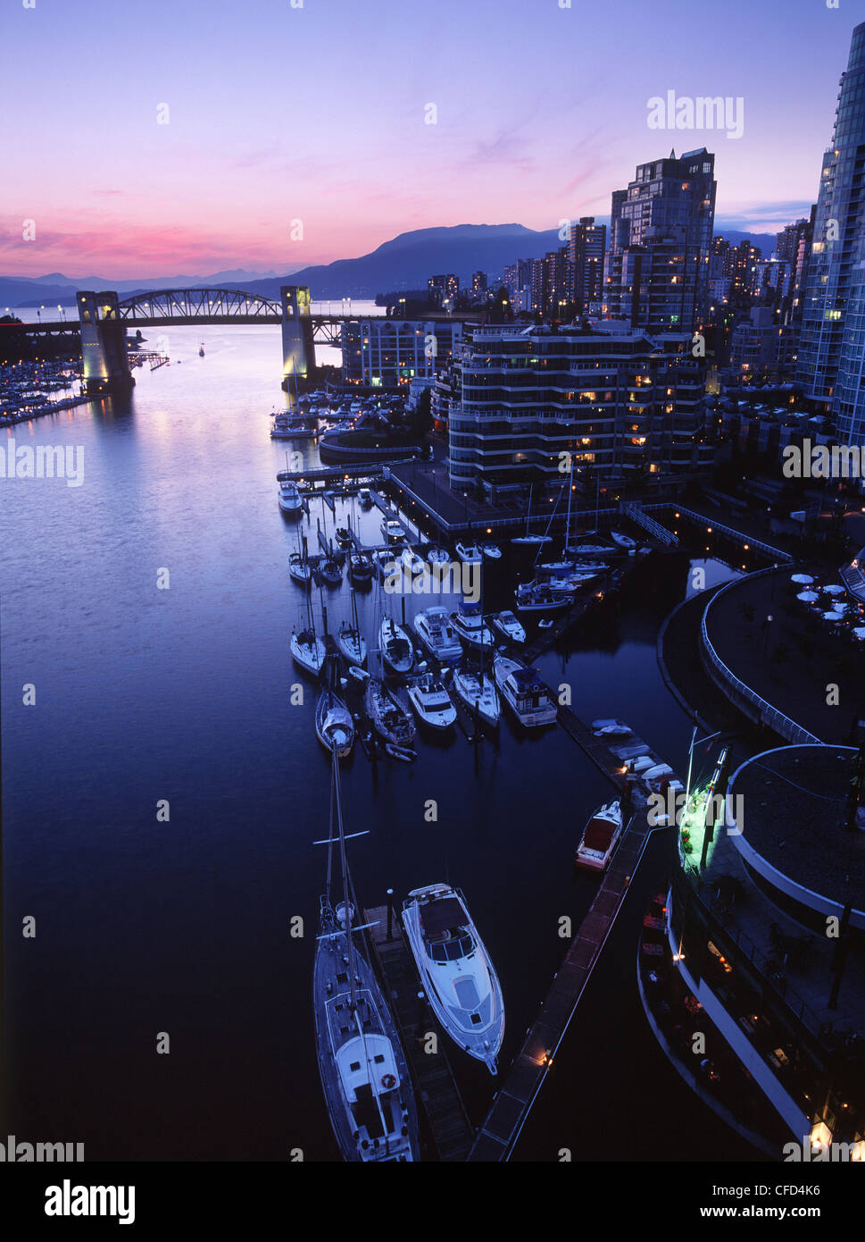 View out False Creek to Burrard Bridge and Inlet at dusk, Vancouver, British Columbia, Canada. Stock Photo