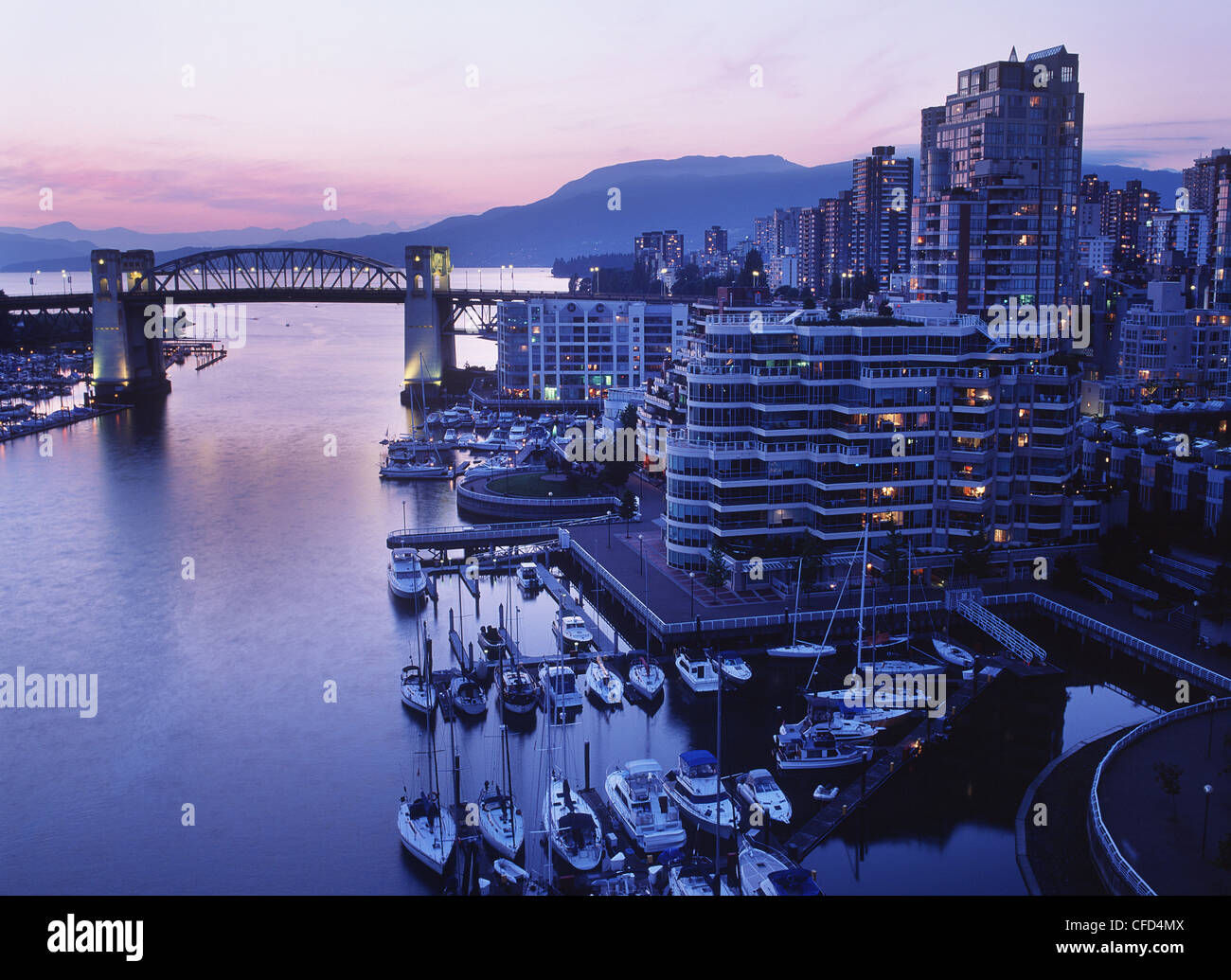 View out False Creek to Burrard Bridge and Inlet at dusk, Vancouver, British Columbia, Canada. Stock Photo