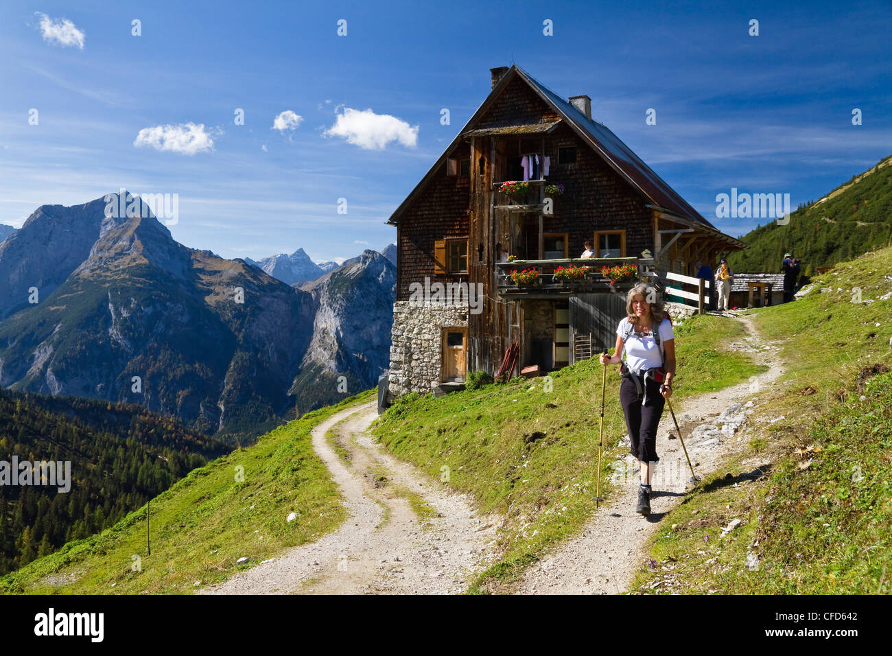 Hiker in front of mountain hut, Plumsjoch hut, Karwendel mountains, Tyrol, Austria, Europe Stock Photo