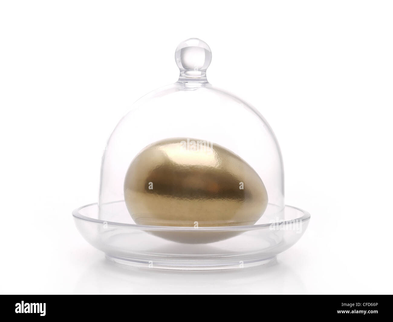 Golden egg under bell jar over white background Stock Photo