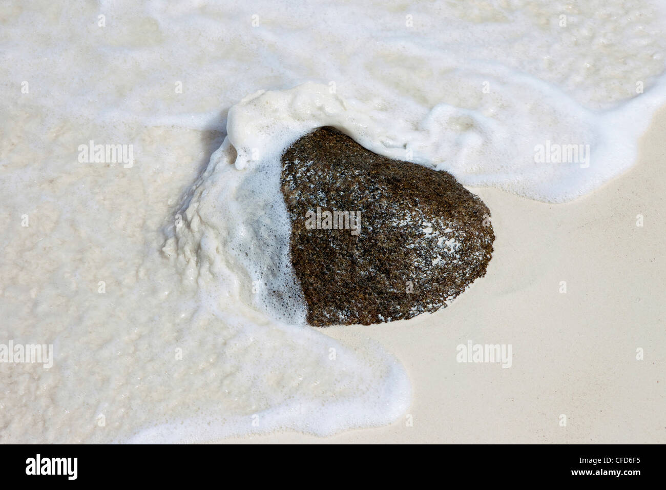 Wave washing around rock on fine white sandy beach, Similan Islands, Andaman Sea, Thailand Stock Photo
