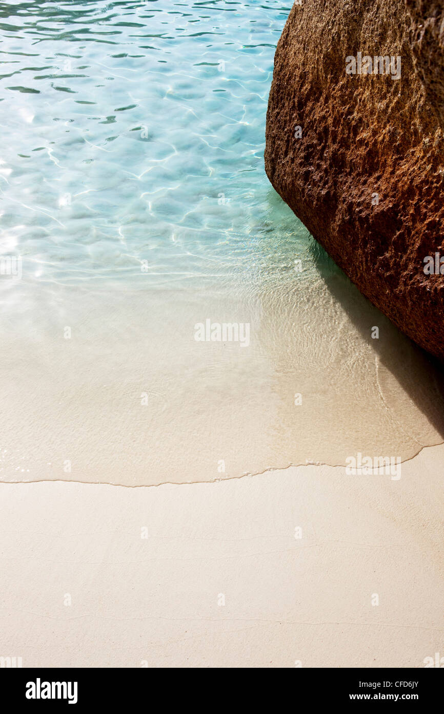 Wave washing around rock on fine white sandy beach, Similan Islands, Andaman Sea, Thailand Stock Photo