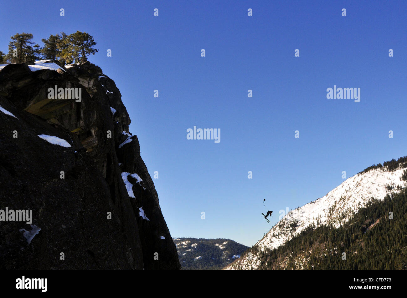 Pro skier Josh Daiek performs a double backflip ski BASE jumping off of Lovers Leap in Strawberry, CA. Stock Photo