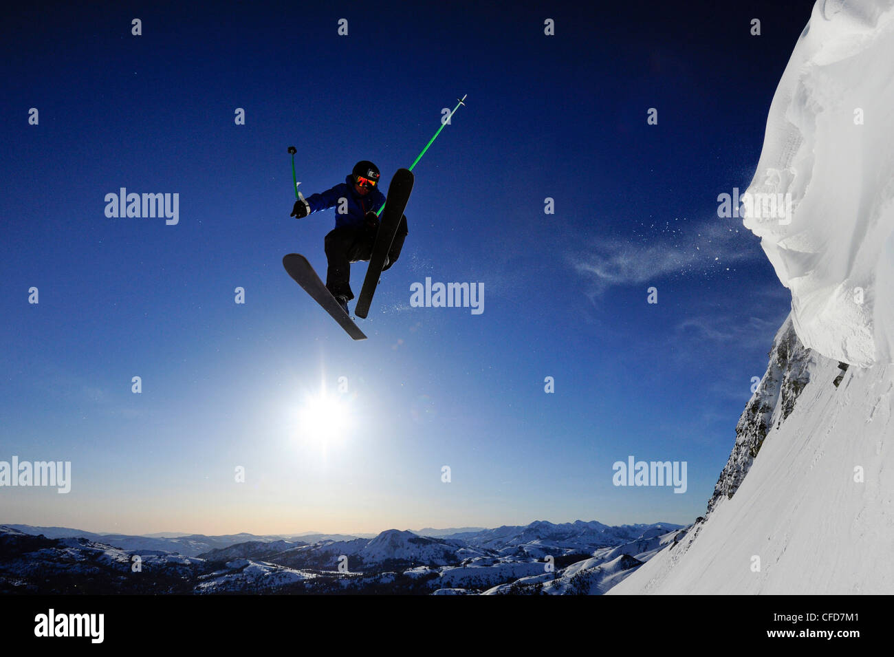 A skier soars through the air at sunrise in the Sierra Nevada mountains near Lake Tahoe, California. Stock Photo