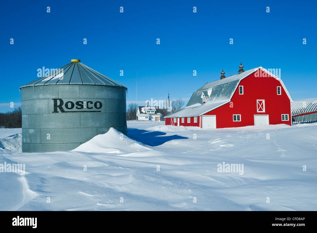 Red barn and grain bins near Torquay Saskatchewan, Canada Stock Photo