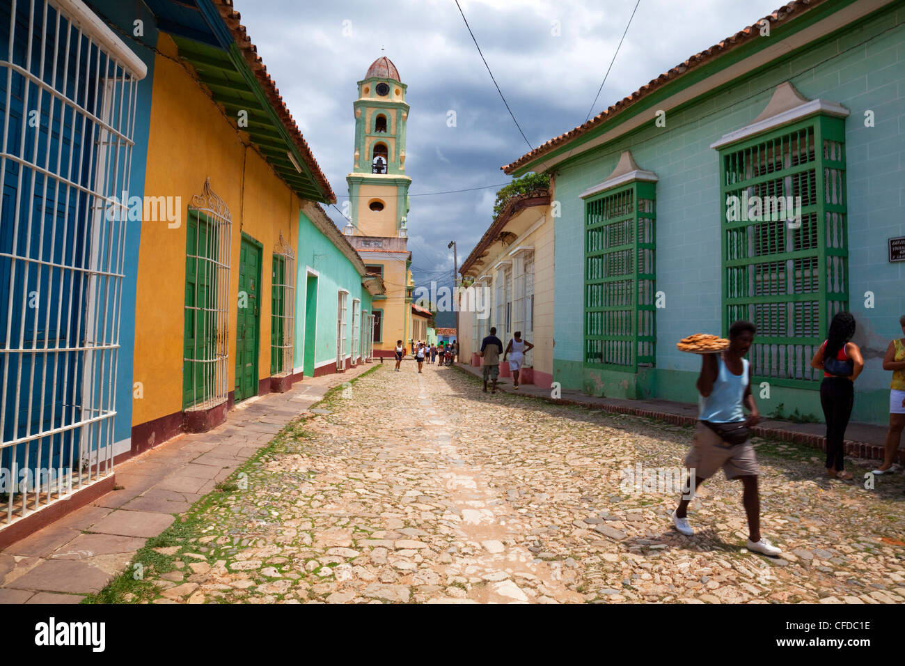 Man carrying tray of pastries along street in Trinidad, Sancti Spiritus Province, Cuba, West Indies, Central America Stock Photo