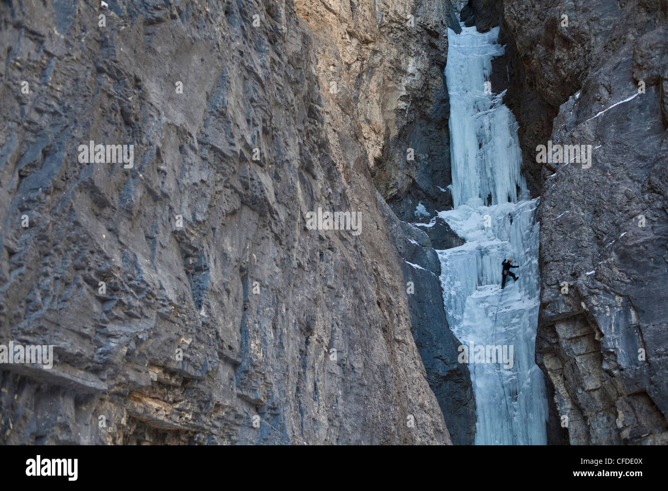 A middle aged man climbc Aquarius WI4, in the beautiful Ghost River Valley, Alberta, Canada Stock Photo