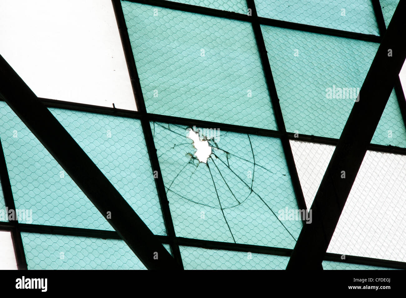 Bullet hole in the windows of an airplane hanger from the Japanese attack on Pearl Harbor. Stock Photo