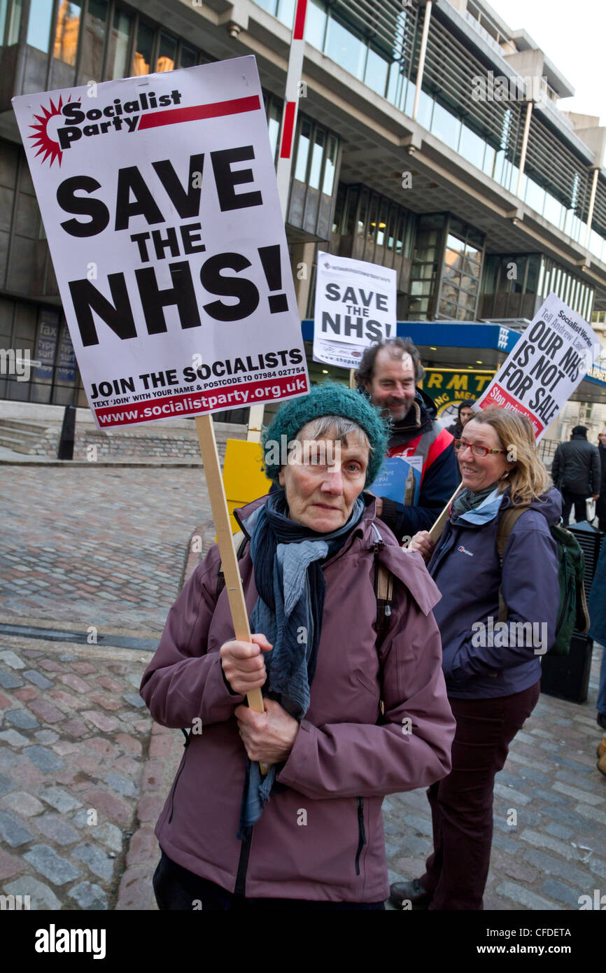 London, UK 7th March 2012. Save our NHS, A NHS protester with a placard saying 'Save the NHS'. Stock Photo