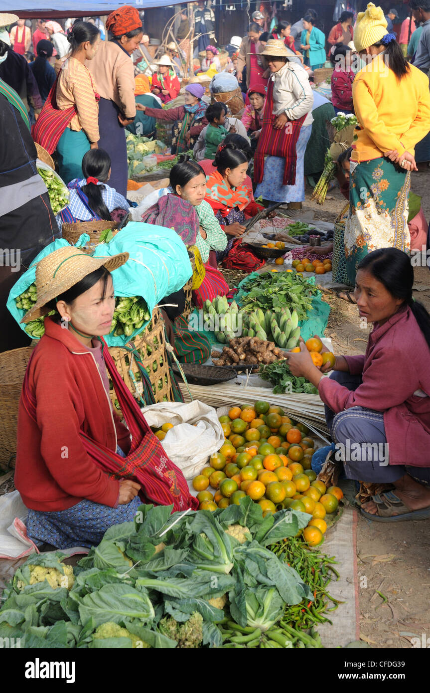 Different tribal people selling vegetable at a local market on the Inle Lake, Shan States, Myanmar, Asia Stock Photo