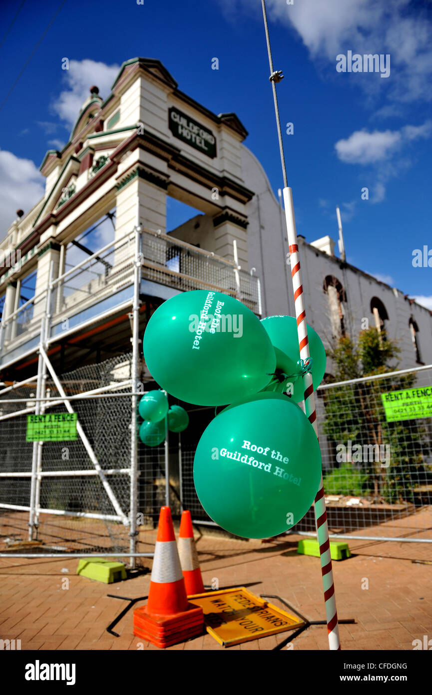 Balloons printed with 'Roof The Guildford Hotel' displayed before the arson-damaged Guildford Hotel. Western Australia Stock Photo