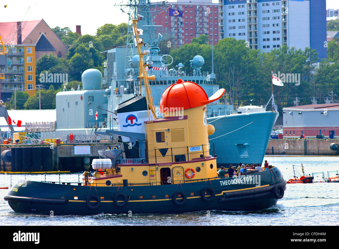 Theadore Tugboat, passing in front of Halifax Naval shipyards, Haliax Harbour, Nova Scotia, Canada Stock Photo