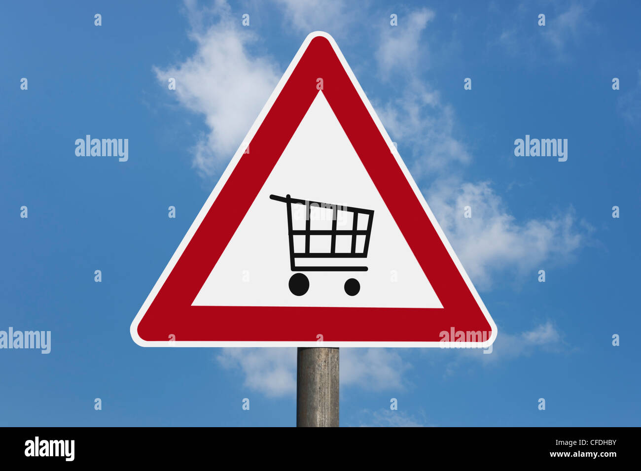 Detail photo of a danger sign with a shopping cart in the middle, background sky. Stock Photo