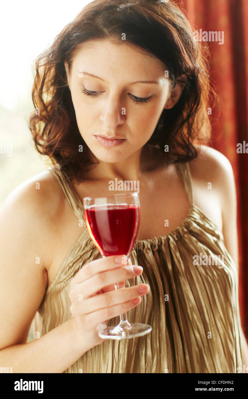 Woman with wine glass looking sad Stock Photo