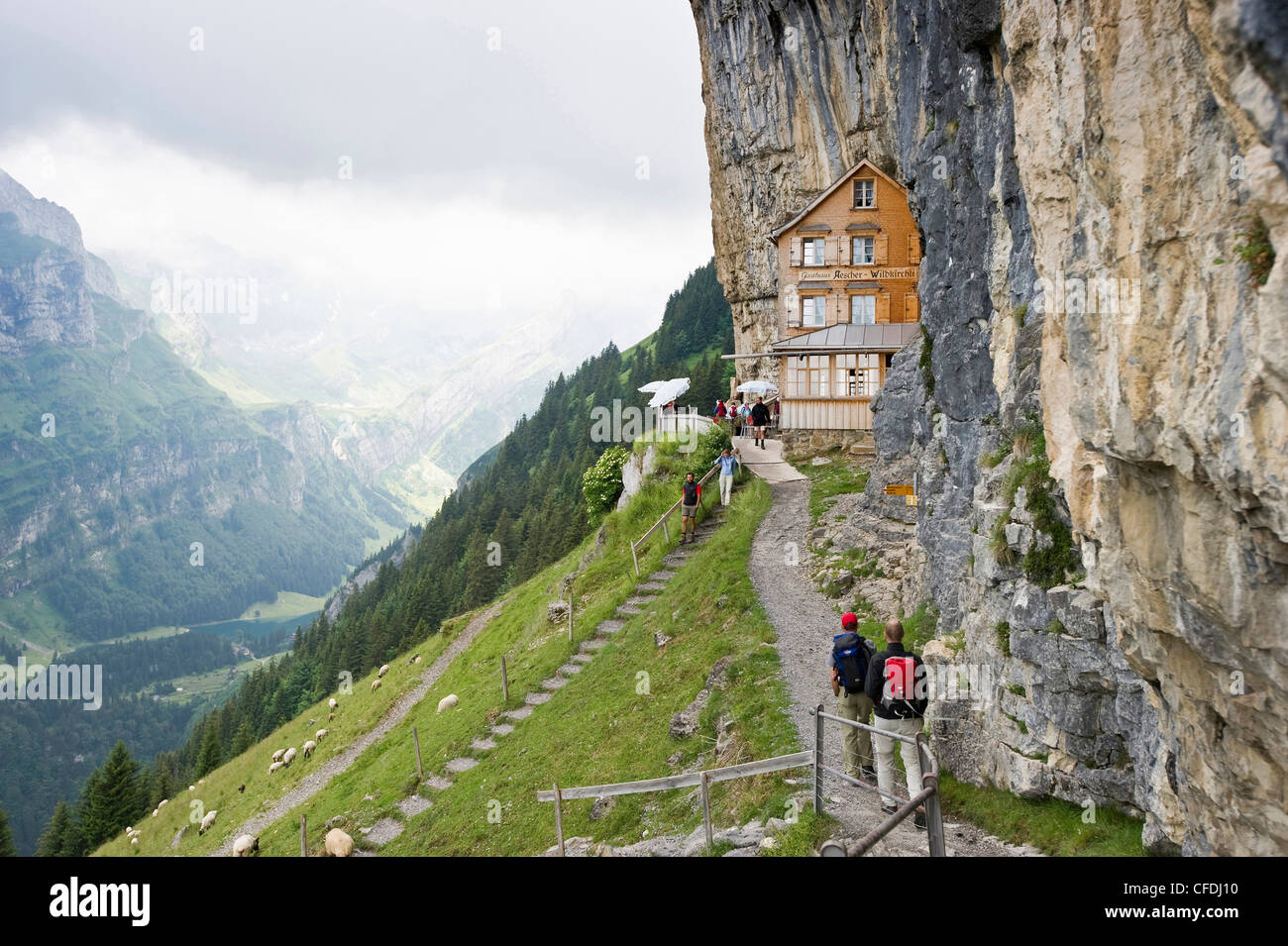 Mountain hikers near mountain inn Aescher, Ebenalp, Alpstein massif, Appenzell Innerrhoden, Switzerland Stock Photo