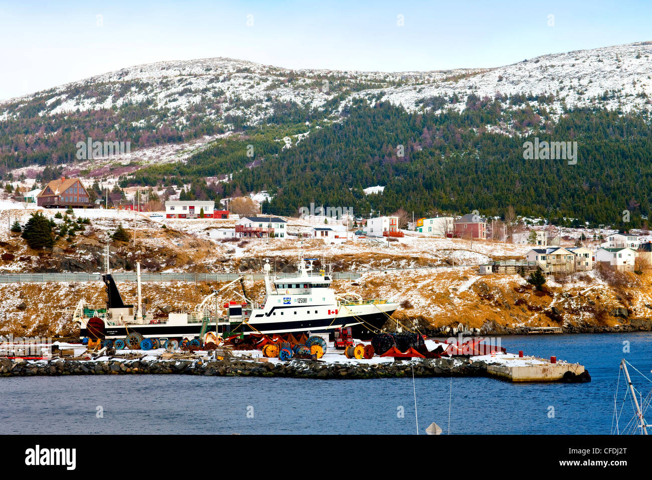 Ship tied up in winter, Bay Bulls, Newfoundland, Canada Stock Photo