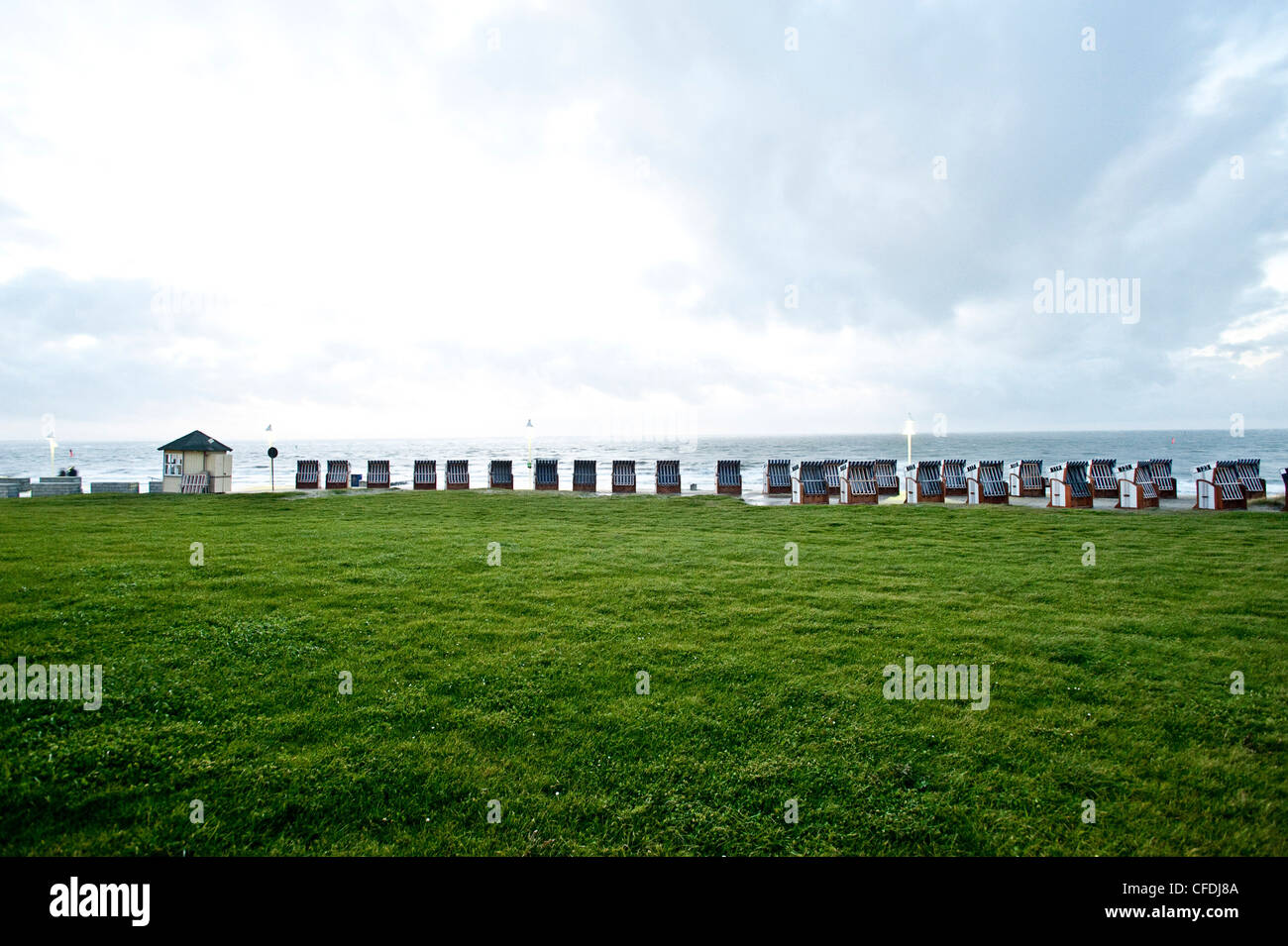 Roofed wicker beach chairs at promenade, Norderney, East Frisian Islands, Lower Saxony, Germany Stock Photo