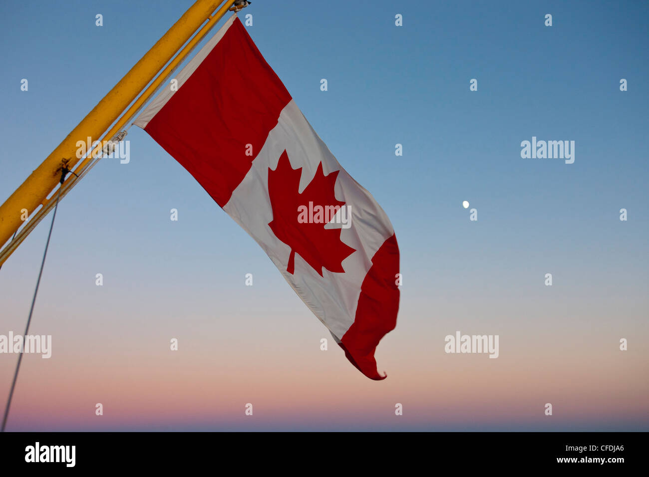 Canadian flag and moon, Bay of Fundy, New Brunswick, Canada Stock Photo