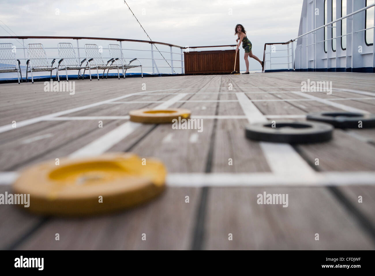 Woman plays shuffleboard aboard cruise ship MS Astor, Transocean Kreuzfahrten, MR, near Kiel, Schleswig-Holstein, Germany Stock Photo