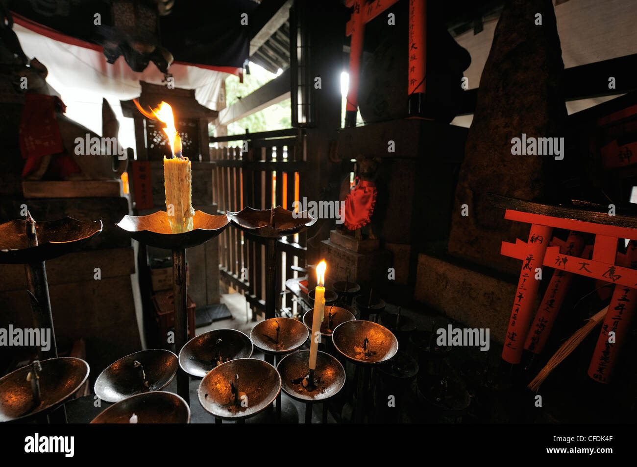 burning candles as donations at Fushimi Inari Shrine, Kyoto, Japan