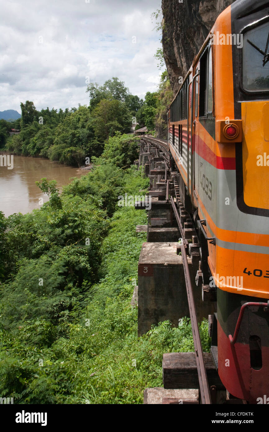 Modern locomotive of tourist train on wooden trestle viaduct of Trans River Kwai Death Railway at Saphan Tham Krasae, near Kanch Stock Photo