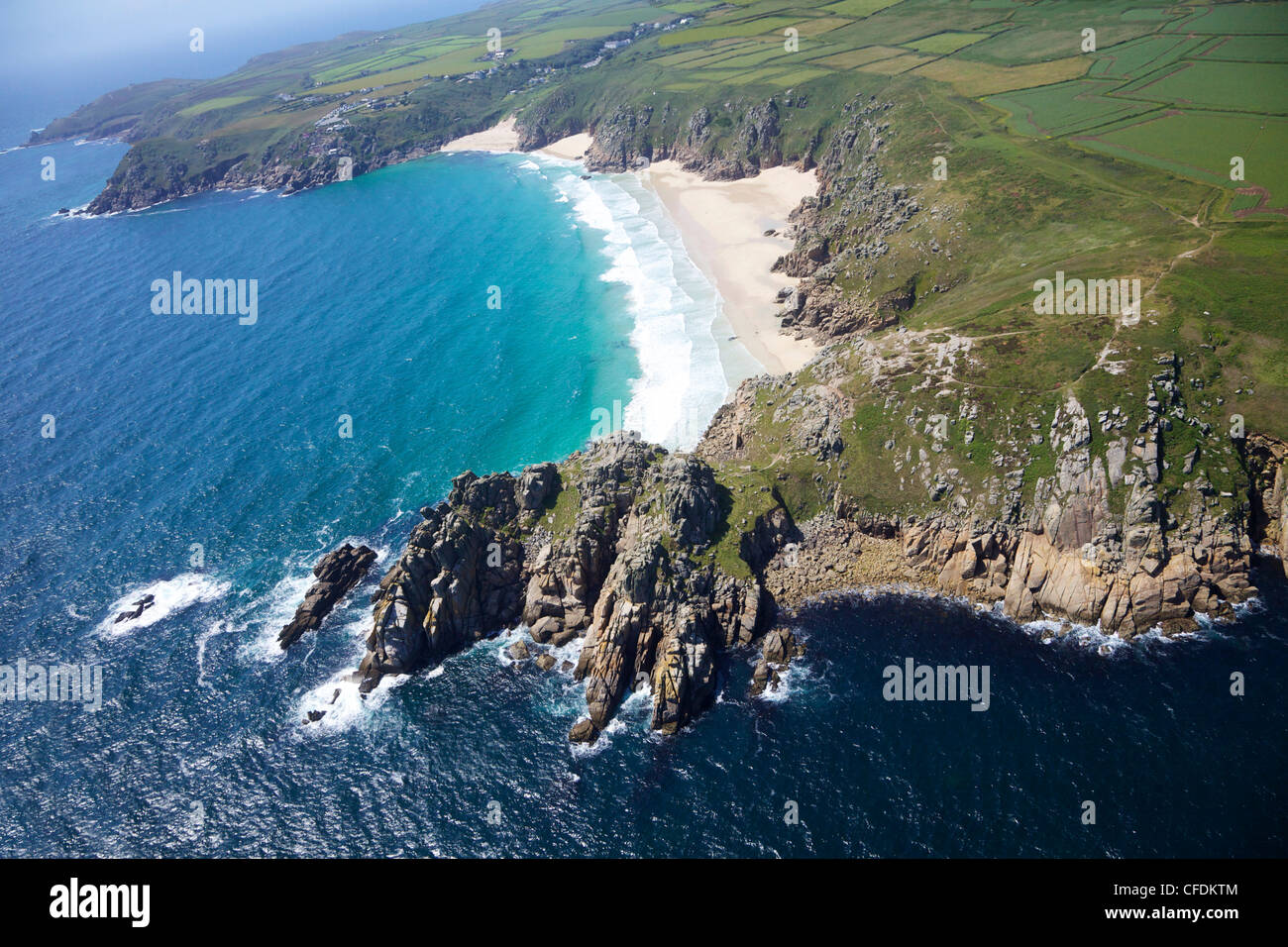 Aerial photo of Treen Cliff and Porthcurno beach looking west to the Minnack Theatre, West Penwith, Cornwall, England, UK Stock Photo
