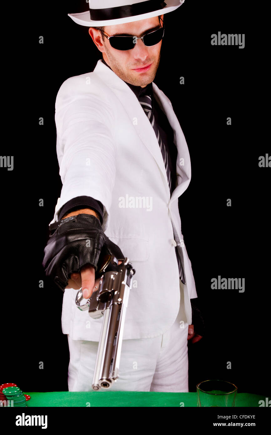 View of a white suit gangster man holding a gun Stock Photo - Alamy