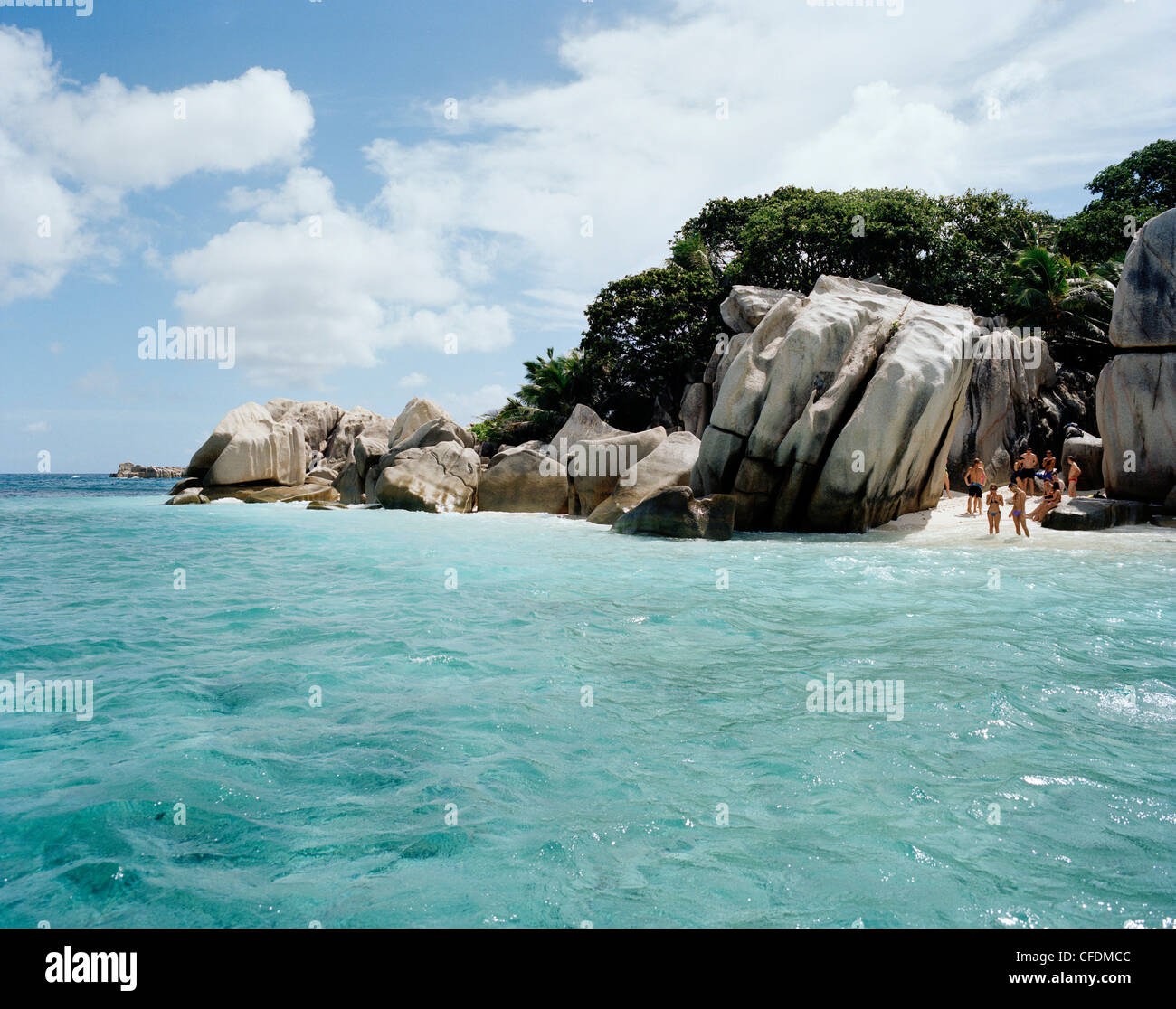 Tourists on the beach of tiny Coco Island, La Digue and Inner Islands, Republic of Seychelles, Indian Ocean Stock Photo
