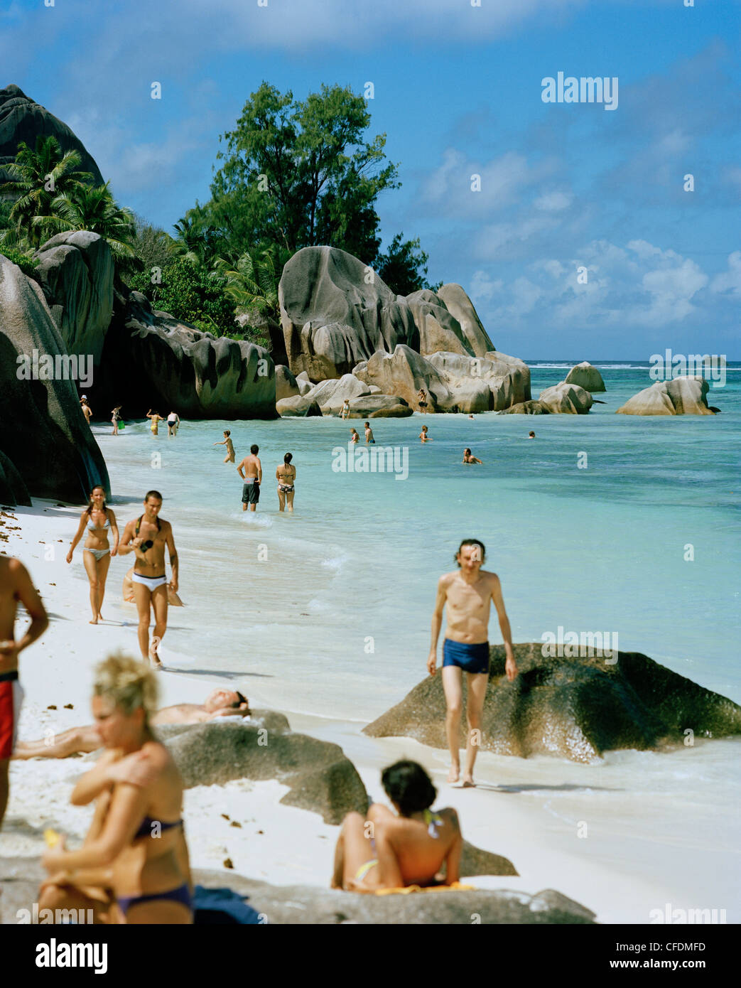 Tourists on worlds most famous beach Anse Source d'Argent with its granitic rocks, south western La Digue, La Digue and Inner Is Stock Photo