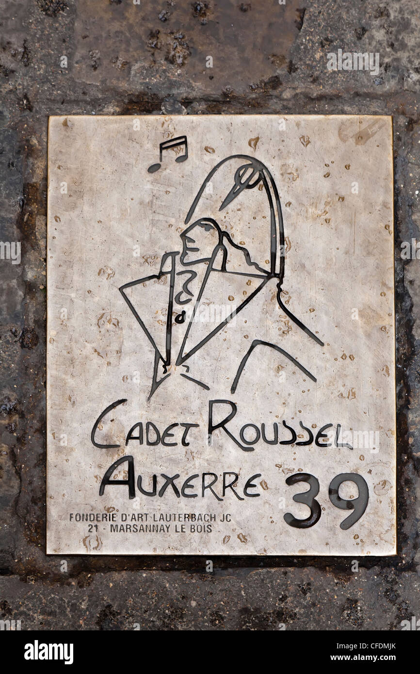 Metal plaque in street marking the Cadet Roussel tourist trail, Auxerre, Burgundy, France Stock Photo