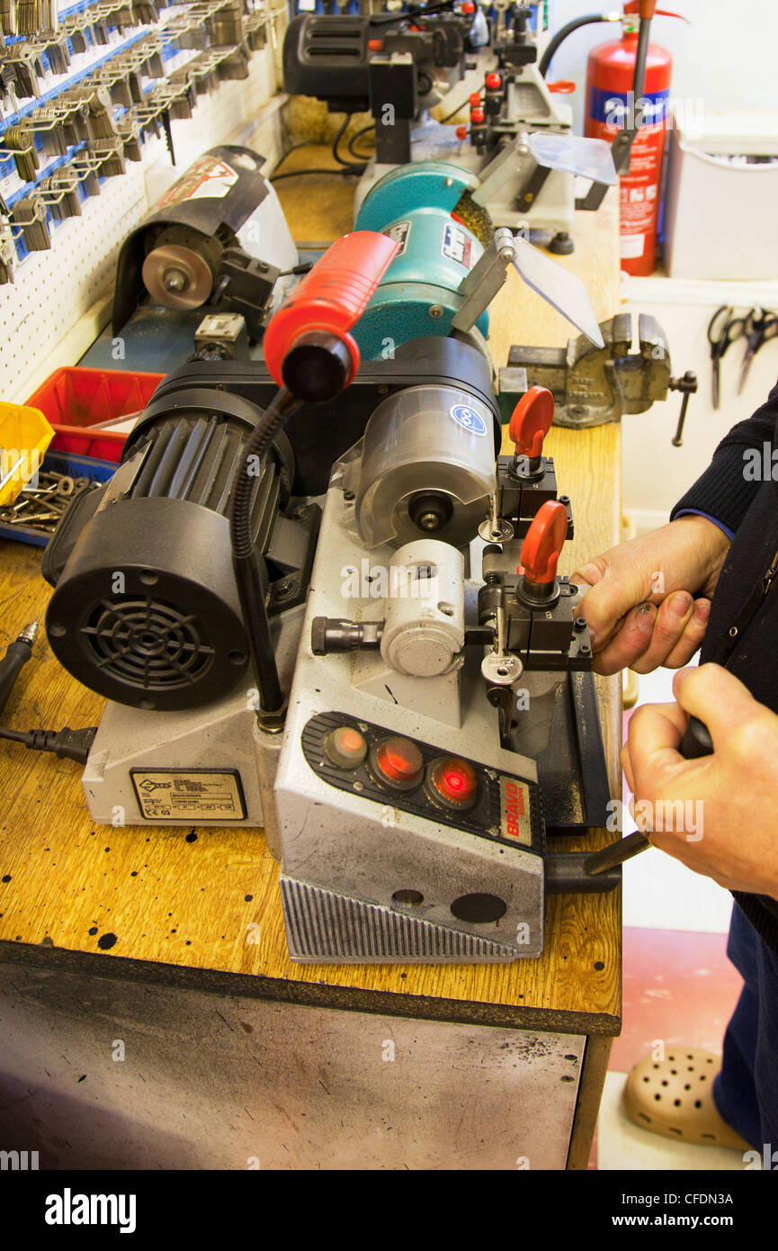 Cylinder yale type key cutting machine being used to copy keys by locksmith making duplicates