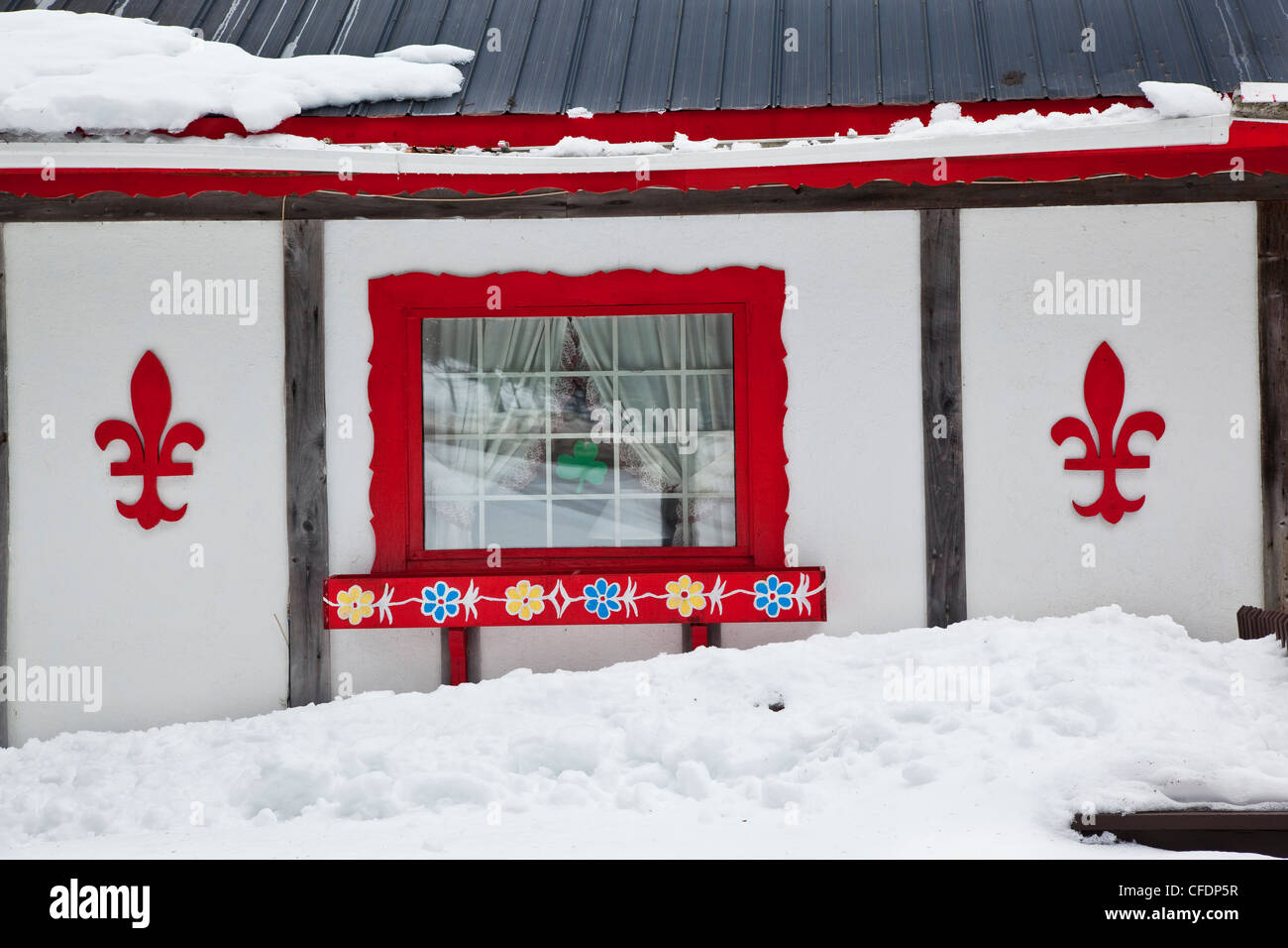 Red fleur-de-lis on painted on a winter cottage in Mont-Tremblant, Quebec, Canada Stock Photo