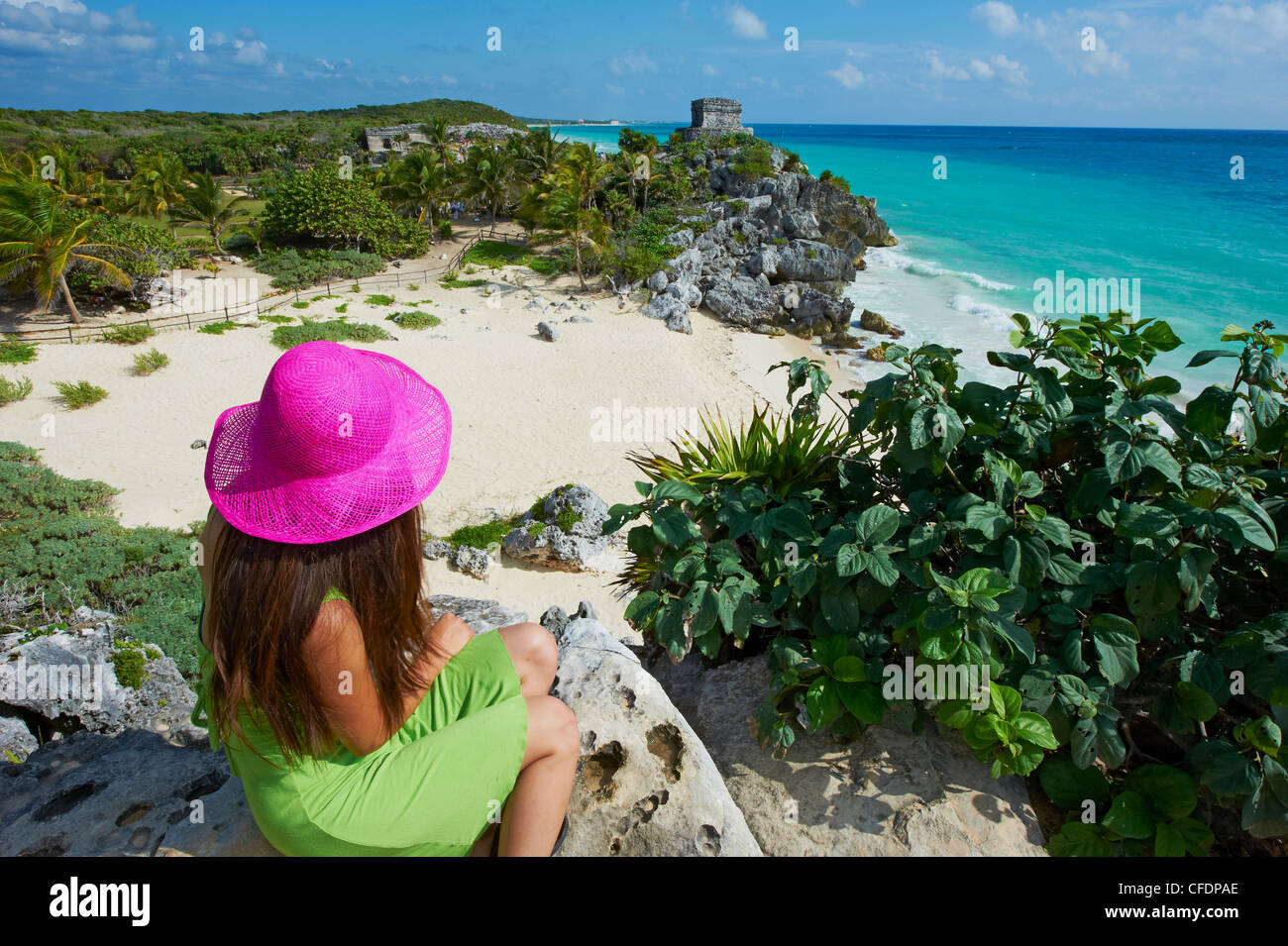 Tourist on the Caribbean coast looking over Tulum Beach to the ancient Mayan site of Tulum, Tulum, Quintana Roo, Mexico Stock Photo